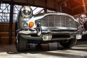 closeup of the headlights and front bumper on a vintage automobile.